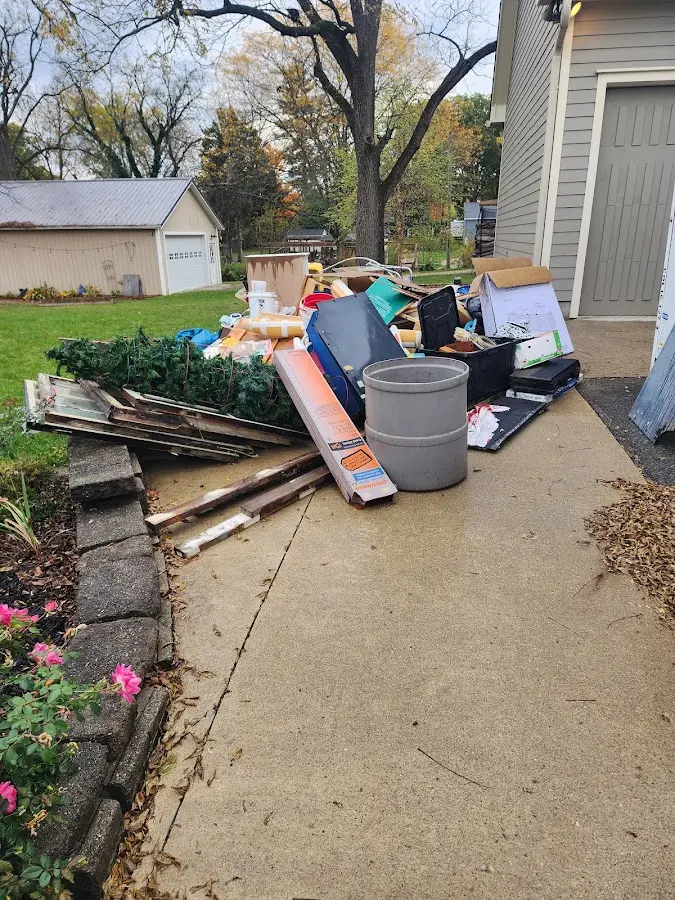 Dumpster being loaded with debris for 30 Yard Dumpster Rental in Madisonville